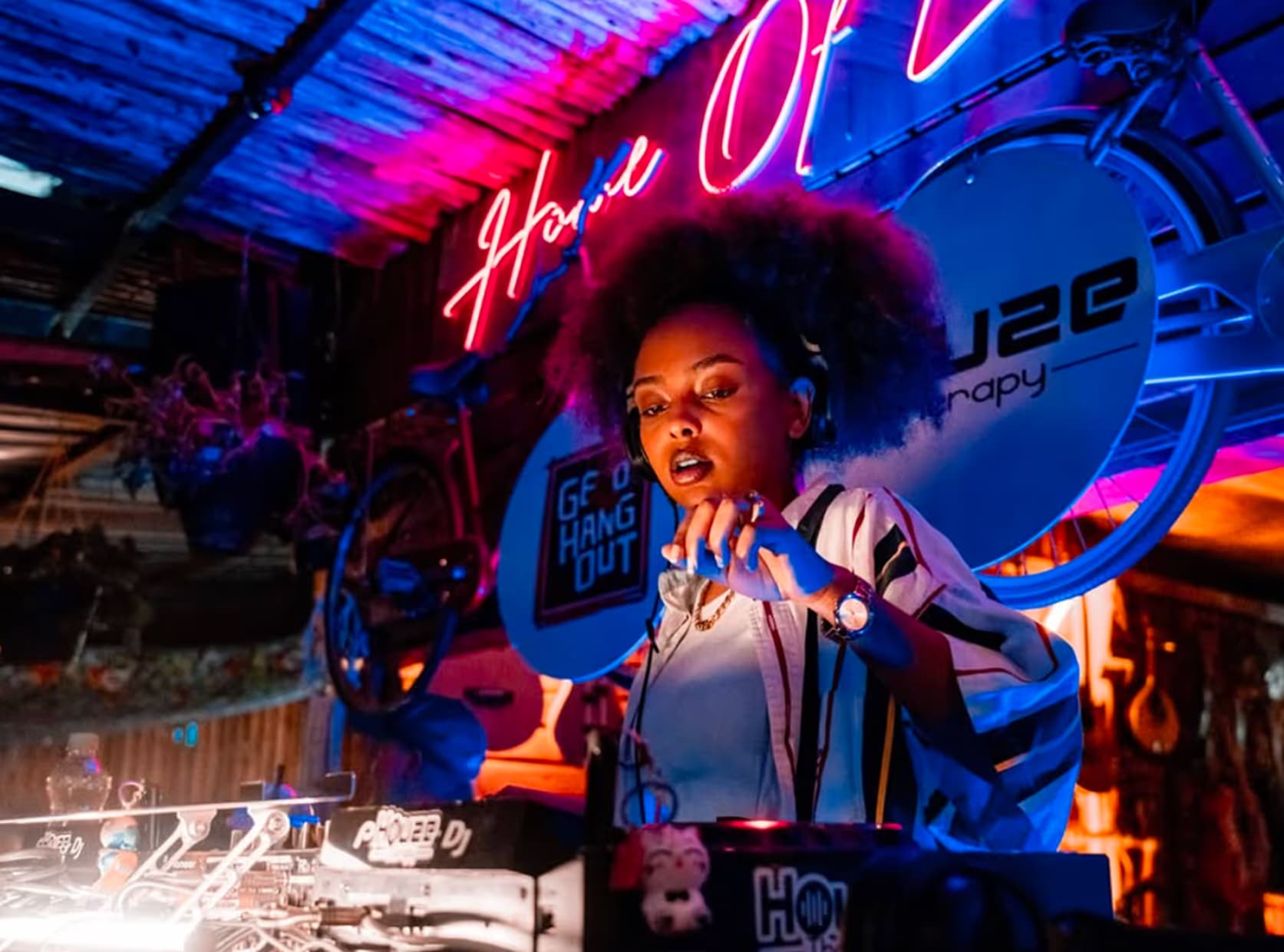 A singer at the keys under neon lights